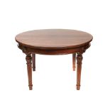 Mesa de comedor circular en madera de raíz con patas en estípite, segundo cuarto del s.XX. Se