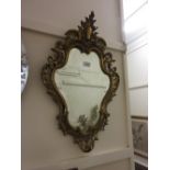 19th Century gilt brass cartouche wall mirror with a bevelled plate together with a brass table
