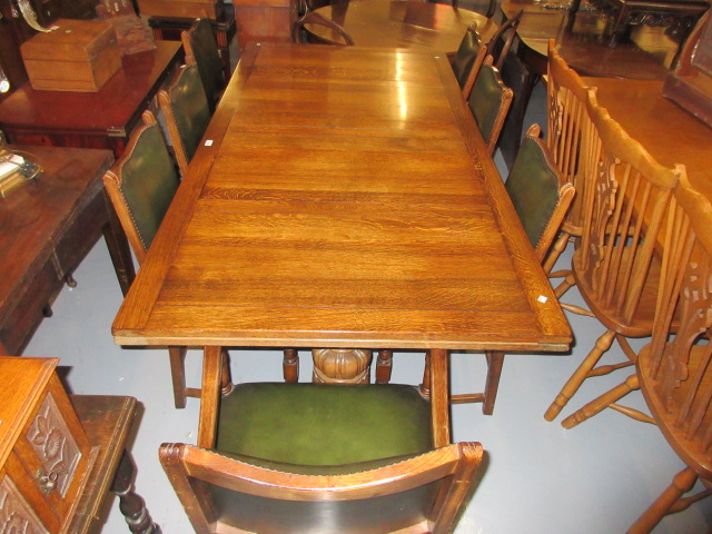 Mid 20th Century oak dining room suite comprising: draw-leaf refectory style dining table raised on