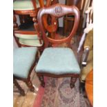 Pair of mahogany balloon back side chairs having carved decoration on turned tapering supports with