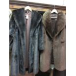 Group of four synthetic fur coats and a bag containing a quantity of various fur muffs, hats etc.