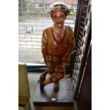 Carved wooden and painted figure of a golfer,