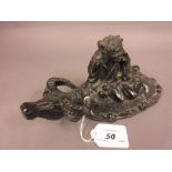 Carved soapstone group of a figure riding a buffalo