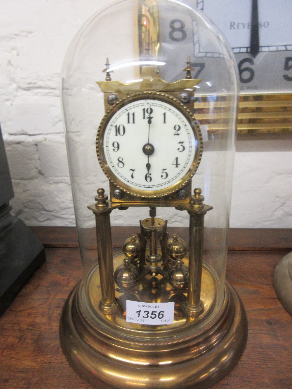 Early 20th Century brass three hundred day clock with glass display dome