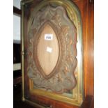 Arts and Crafts copper floral embossed shaped frame and a modern arched top mirror