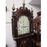 George III mahogany longcase clock, the arched hood with shaped pediment above an arched door,