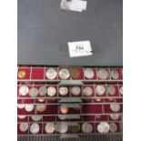 Collection of various coins housed in plastic trays