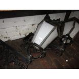 Pair of wall mounted cast iron copper topped lanterns with opaque Perspex glazing (at fault)