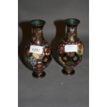 Pair of Japanese cloisonné baluster form vases decorated with panels of flowers,