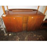 1970's Walnut semi bow fronted sideboard having two flush panelled doors on low tapering swept