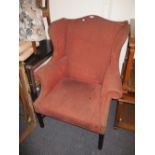 Reproduction burgundy upholstered wing back armchair raised on mahogany square chamfered supports