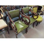 Pair of reproduction mahogany open elbow chairs having green leather upholstery on sabre leg front