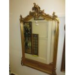 19th Century French gilded composition wall mirror with shaped floral and scroll surmount