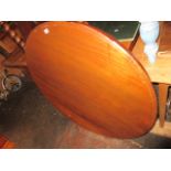 Circular mahogany loo table on a faceted tapering column with tri-form base and low supports