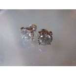 Pair of 18ct white gold diamond solitaire screw back stud earrings, approximately 2.