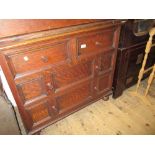 20th Century oak chest of two short over two long drawers with knob handles raised on turned