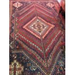 Shiraz rug with central medallion and radiating boteh design with corner designs and borders,