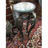 19th Century Chinese carved hardwood vase stand with a marble inset top above a floral carved