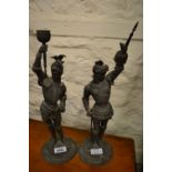 Pair of late 19th Century spelter candlesticks in the form of knights in armour (at fault)