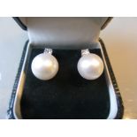 Pair of 18ct white gold South Sea pearl and diamond stud earrings, the diamonds approximately 0.