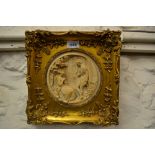 Circular reconstituted marble plaque of a lady and gentleman in high relief in a gilt frame