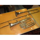Silvered brass tenor horn and a trombone