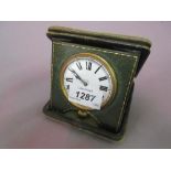 Early 20th Century Swiss nickel plated travel watch in a folding green leather covered case,