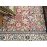 Turkish Hereke carpet with an all-over stylised floral design on a pink ground with borders,