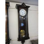 Vienna type wall clock with a stained wooden case with spiral twist half columns,