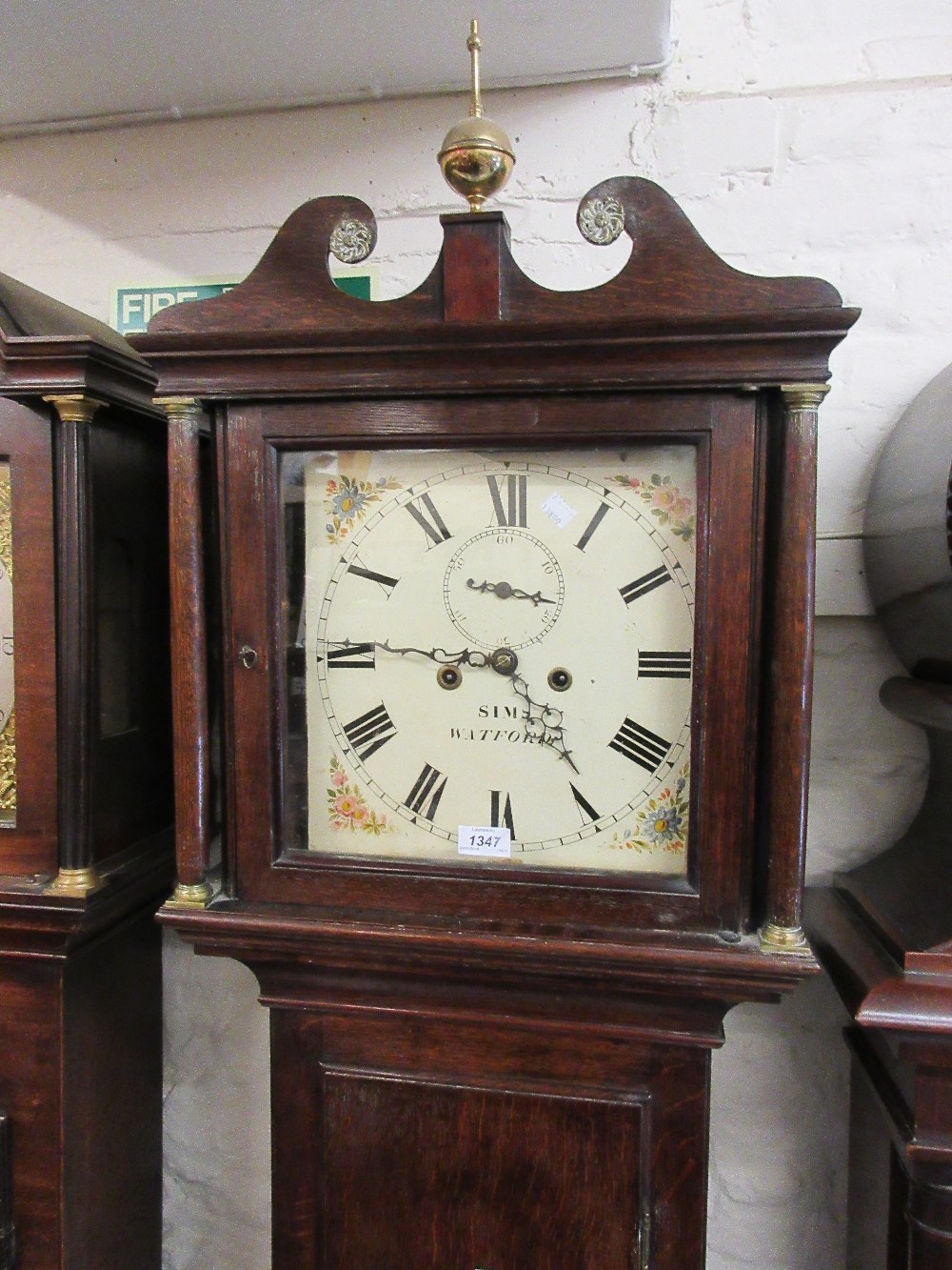 George III oak longcase clock with a square hood above rectangular panelled door and a shaped