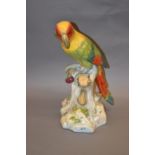 Large 19th Century porcelain figure of a parrot on a tree trunk, marked with a blue cross below a T,