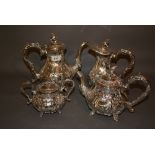 Silver plated four piece tea service having floral engraved and embossed decoration with bird