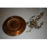 Large circular brass charger decorated with peacocks and a five branch brass hanging chandelier (at