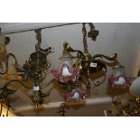 Brass three branch chandelier with pink and clear frosted glass shades,