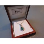 18ct White gold pear shaped emerald and diamond pendant on an 18ct white gold chain,