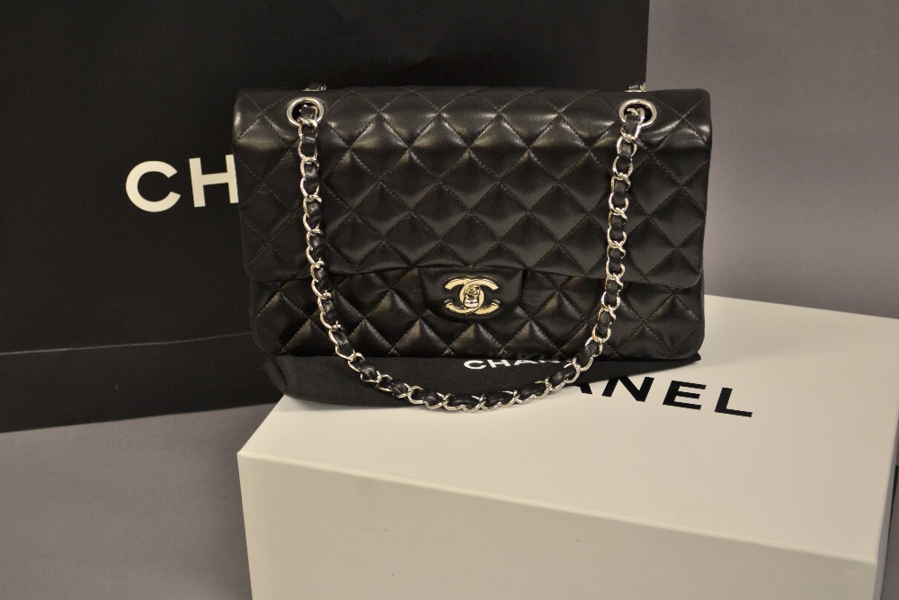 Ladies Chanel Uni black quilted handbag with original guarantee card, dust cover,