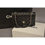 Ladies Chanel Uni black quilted handbag with original guarantee card, dust cover,