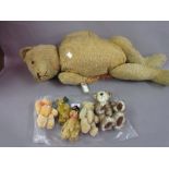 Group of five small articulated plush teddy bears and another larger teddy bear (at fault)