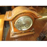 Oak cased mantel clock having circular silvered dial with two train movement