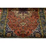 Meshed rug with medallion and all-over floral design on a rose ground with borders,
