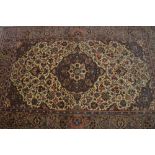 Kirman rug with medallion and all-over floral design on an ivory ground with corner designs and