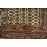 Beige ground Bokhara pattern machine rug, 1.9m x 1.