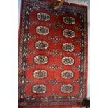 Small hand made rug having multiple gol design on a red ground with borders, 3ft x 2ft,