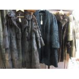 Two dark brown three quarter length fur coats together with a ladies half length dark brown fur