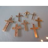 Group of eight various 9ct yellow gold crucifix pendants