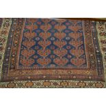 Kurdish rug of all-over floral design with multiple borders on a blue ground,