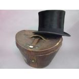 19th Century brown leather hat box containing a top hat by Dunn & Co.