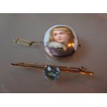 19th Century oval porcelain brooch painted with a portrait of a boy,