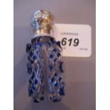 Victorian blue overlay glass perfume bottle with ornate white metal top and stopper,