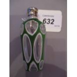 Green and white double overlay perfume bottle with ornate white metal top and stopper,